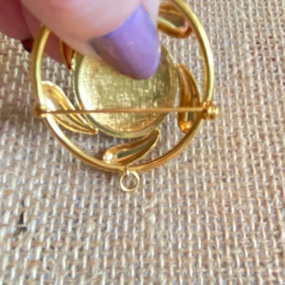 Convertible brooch and pendant circle with red enamel center in goldtone metal
